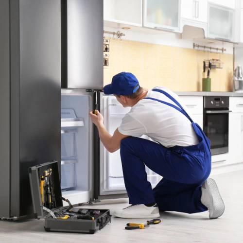 Technician repairing a Haier fridge in Sydney